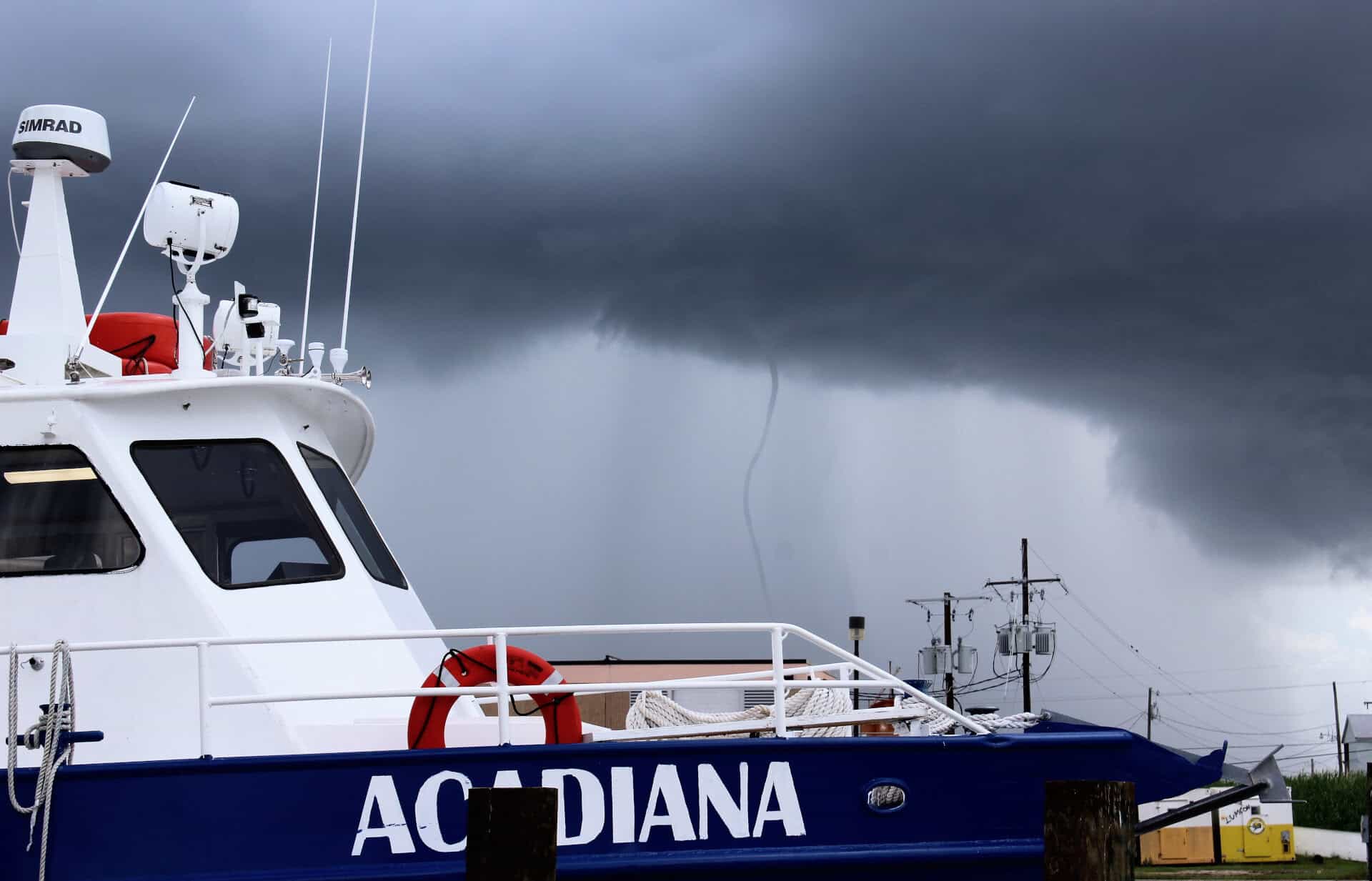 A ship labeled Acadiana positioned with a stormy sky