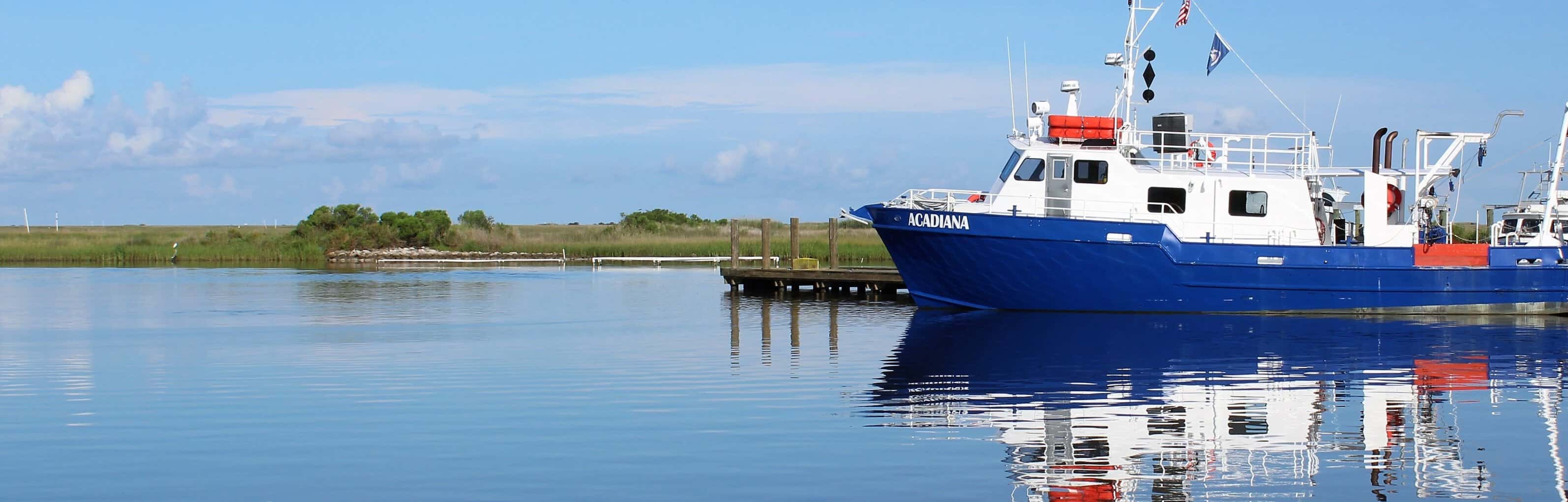 The Acadiana sitting on calm water