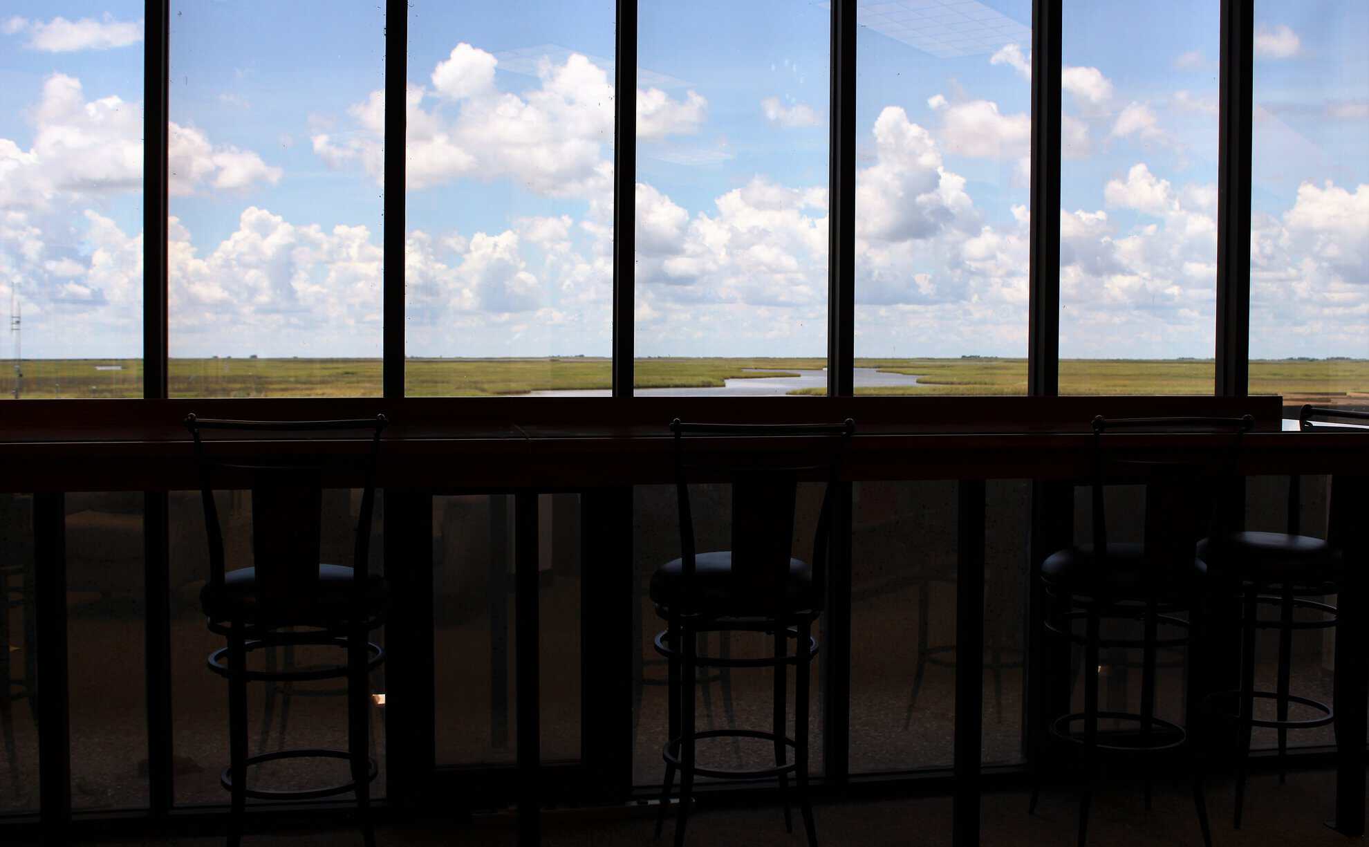A bar table positioned to view the wetlands in the distance