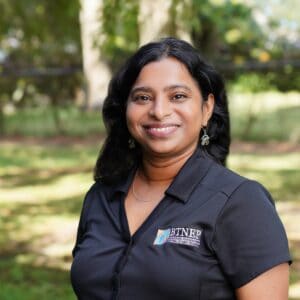 Portrait of Siva Nunna outdoors with trees in the background.